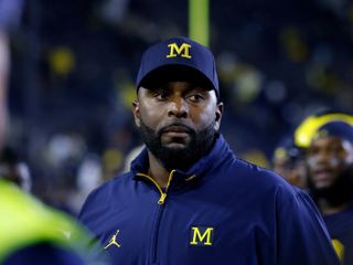 Fired Michigan football coach charged with home invasion and stalking