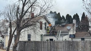 Crews battle house fire in windy conditions