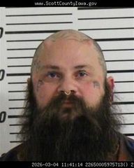 A Davenport man known as 'The Human Dinosaur Boy,' wife face multiple weapons charges