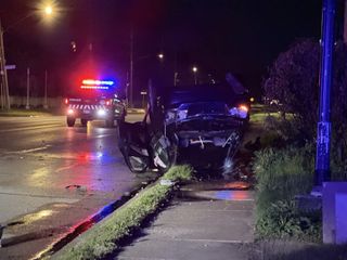 Police investigate after car flips over on River Drive, Davenport