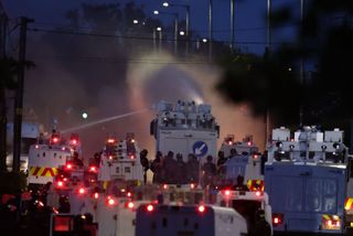 Police blast water cannons at protesters amid unrest over stabbing in Belfast