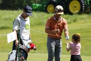 Kids line up to get autographs from the Savannah Bananas at the John Deere Classic