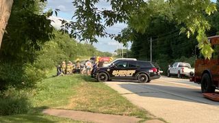 Emergency responders extricate man from car at crash site on Route 150