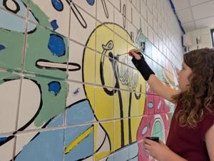 Students leave their mark on Earl Hanson Elementary’s cafeteria mural