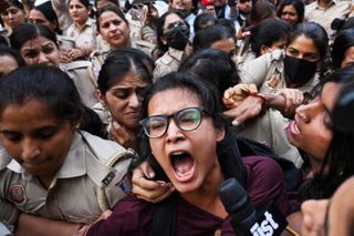 Crowds throng New Delhi and wave Indian flags amid escalating protests